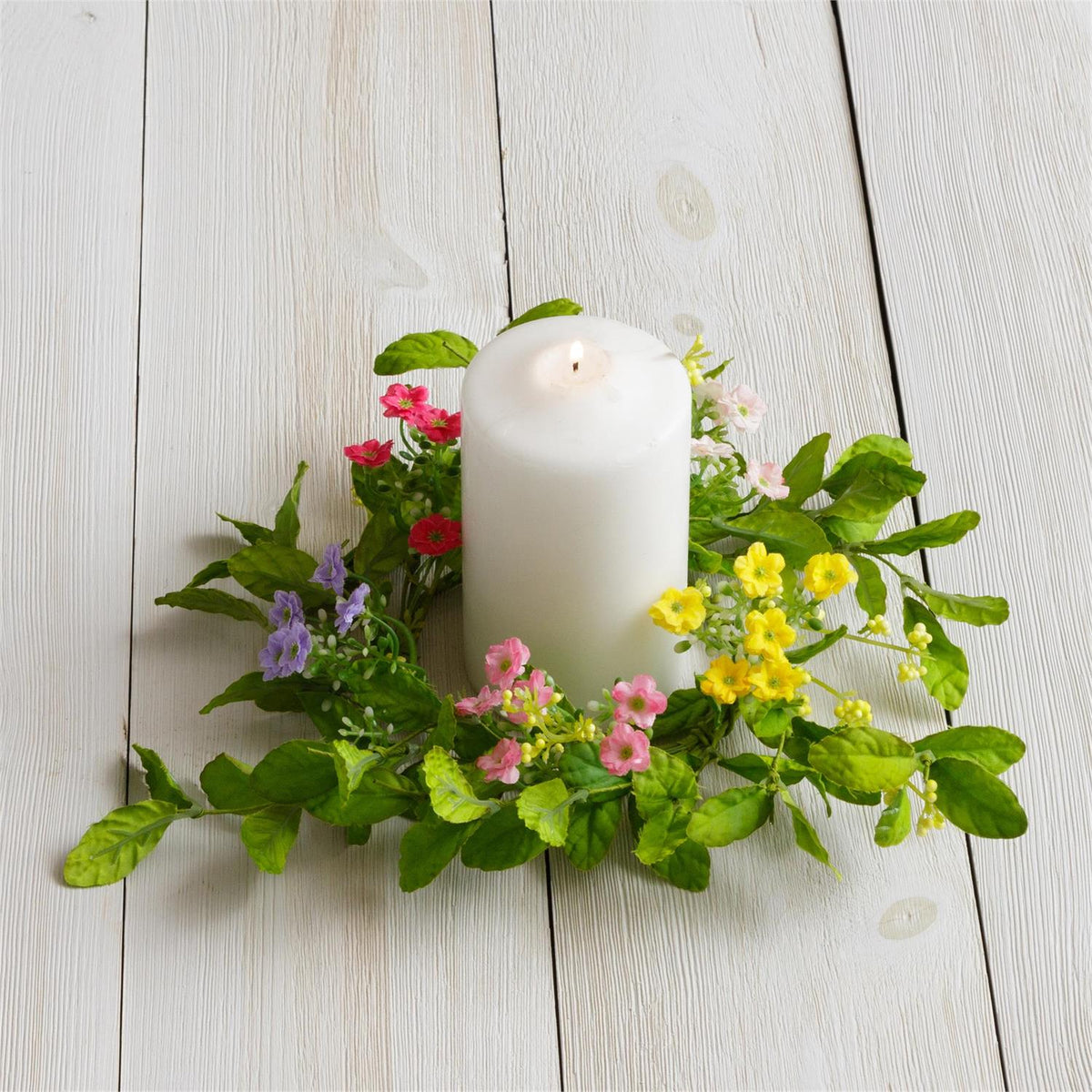 Candle with floral ring for candle detail.