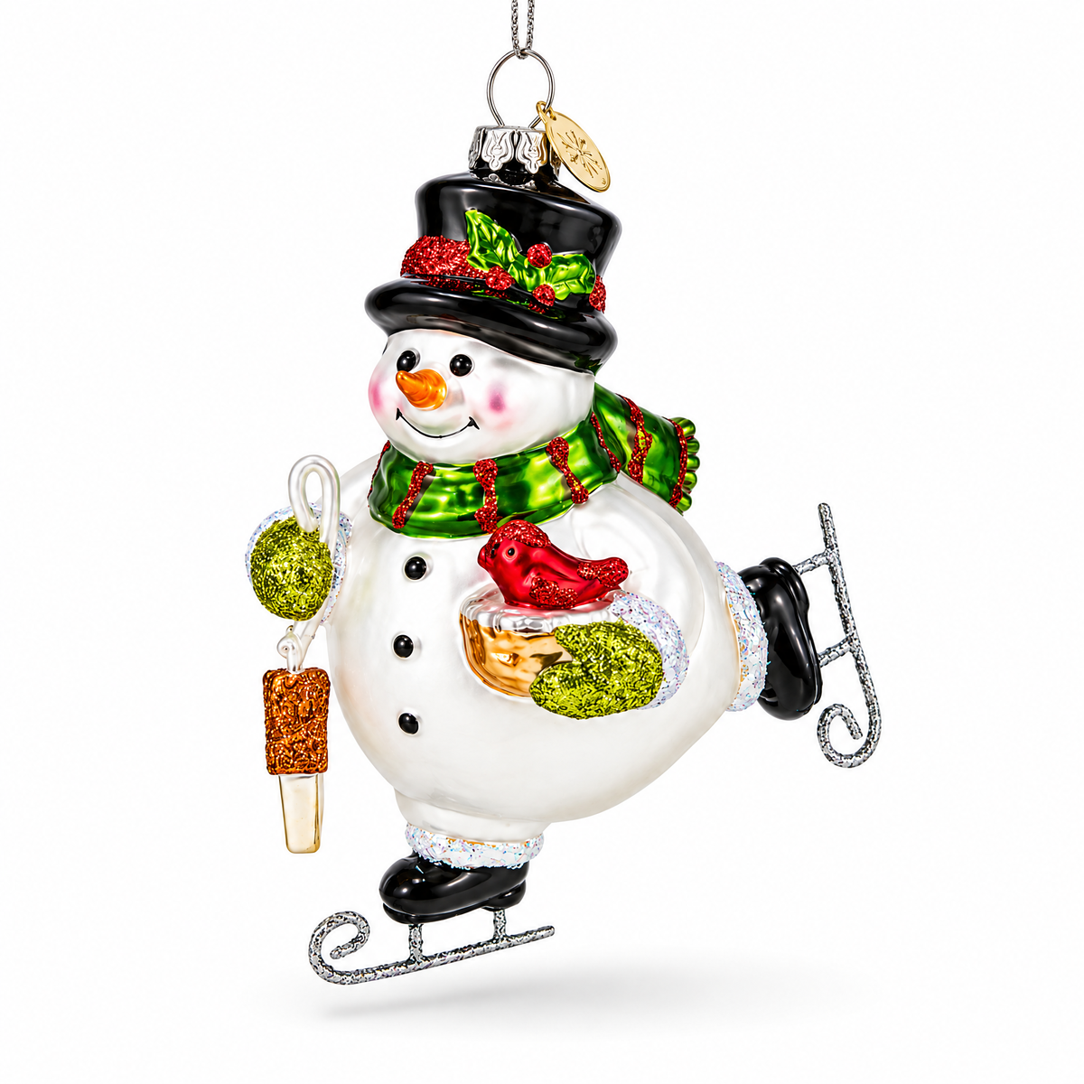 White glass snowman ornament ice skating with a cardinal and a top hat.