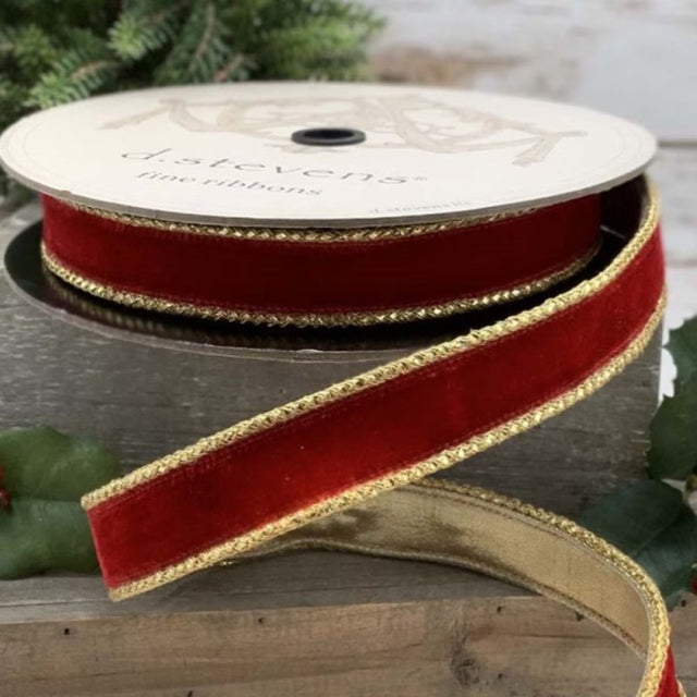 Red velvet ribbon with a gold braid edge, shown as a roll.