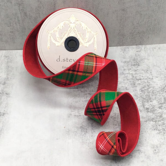 Red ribbon with red and green tartan plaid running on the diagonal.