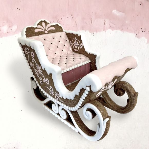 Gingerbread sleigh decoration with piped icing detail.
