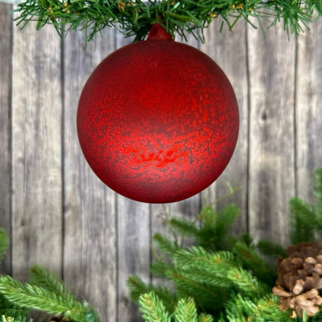 Matte red mercury glass ball ornament with a vintage finish.