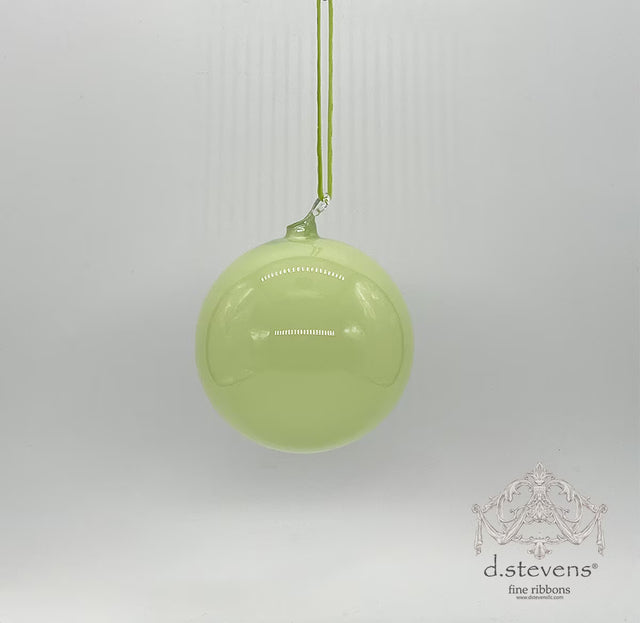 Light sage glass ball ornament with a smooth finish.