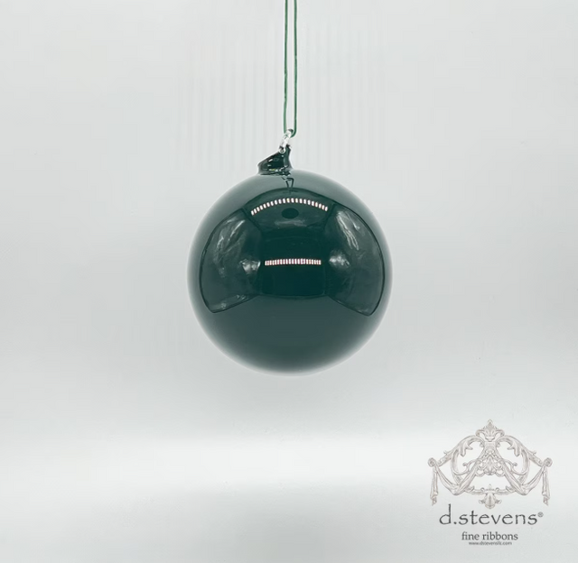 Green glass ball ornament with a deep forest tone.