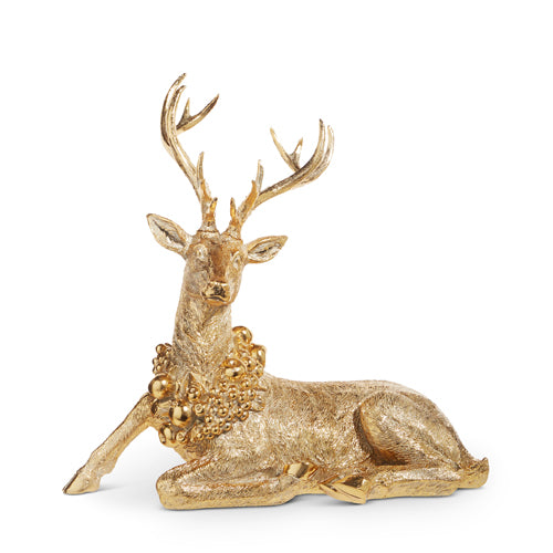 Gold sitting deer figurine wearing a wreath.