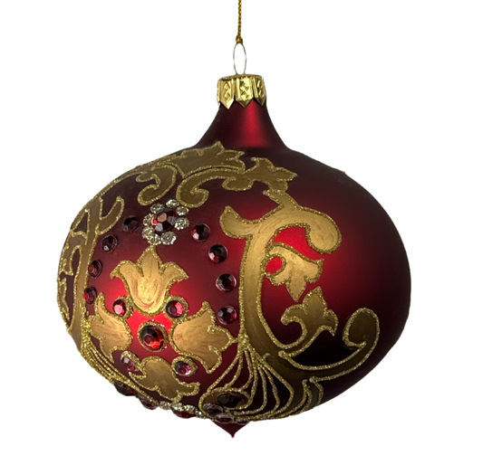 Vintage glass onion ornament with gold scrollwork.