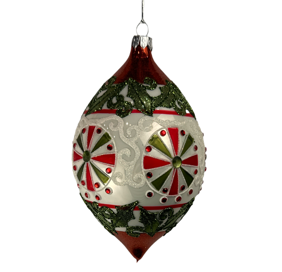 Red and white teardrop ornament with pinwheel medallions and holly.