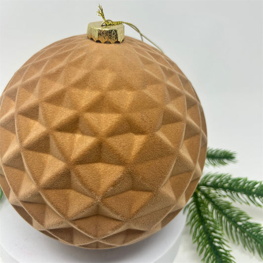 Beige flocked diamond ball ornament with a tailored pattern.