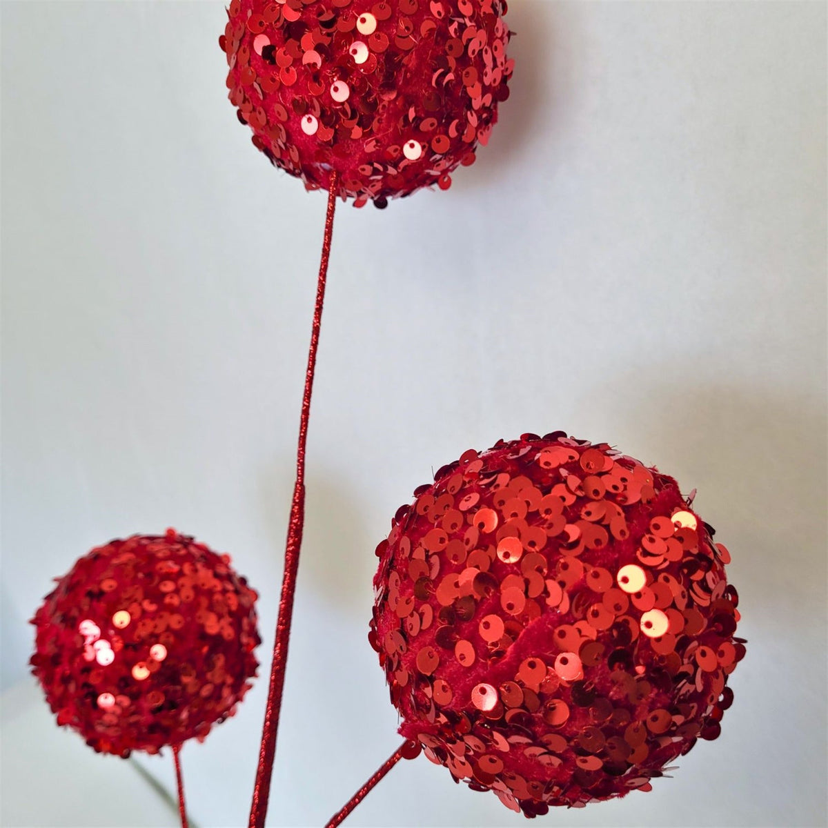 Red sequin ball spray with clustered balls.