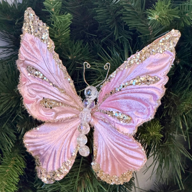 Light pink butterfly ornament with layered mystic wings.