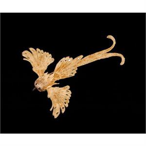Gold velvet clip-on ornament with velvet wings spread in flight on a fastening clip.