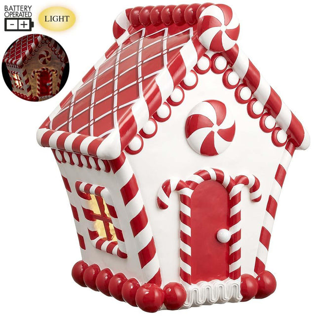 Red and white candy house village piece with glowing LED lights.
