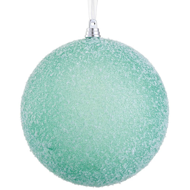 Green plastic ball ornament with a snowy finish.