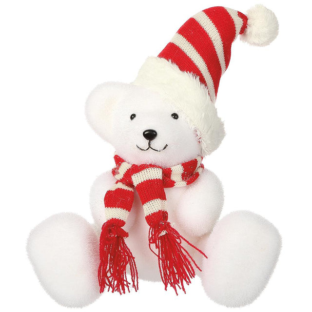 White bear figurine in a red hat and scarf.