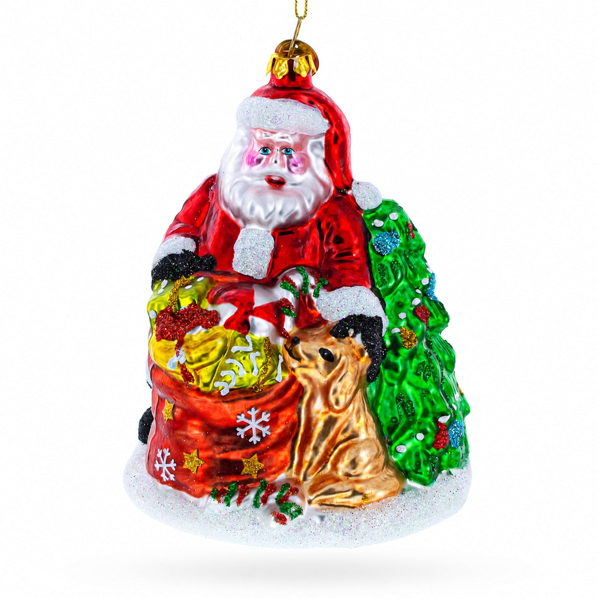 Red glass Santa ornament with a sack of gifts and a golden dog beside a tree.