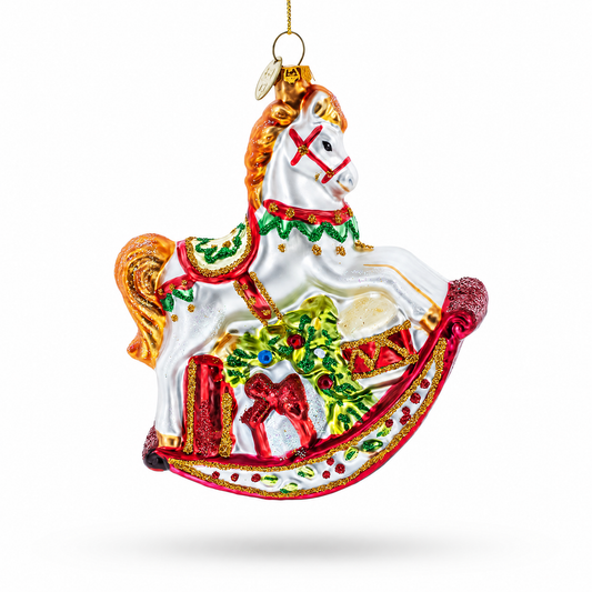 White glass rocking horse ornament with a red and gold rocker and a wreath.