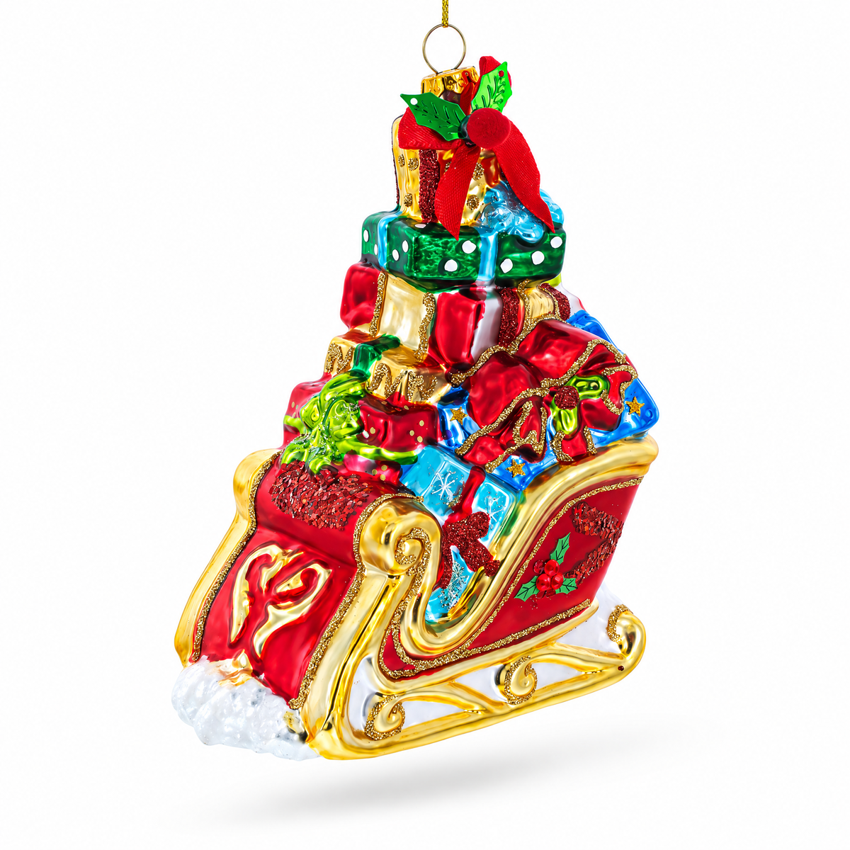 Red glass sleigh ornament piled high with wrapped gifts and gold runners.