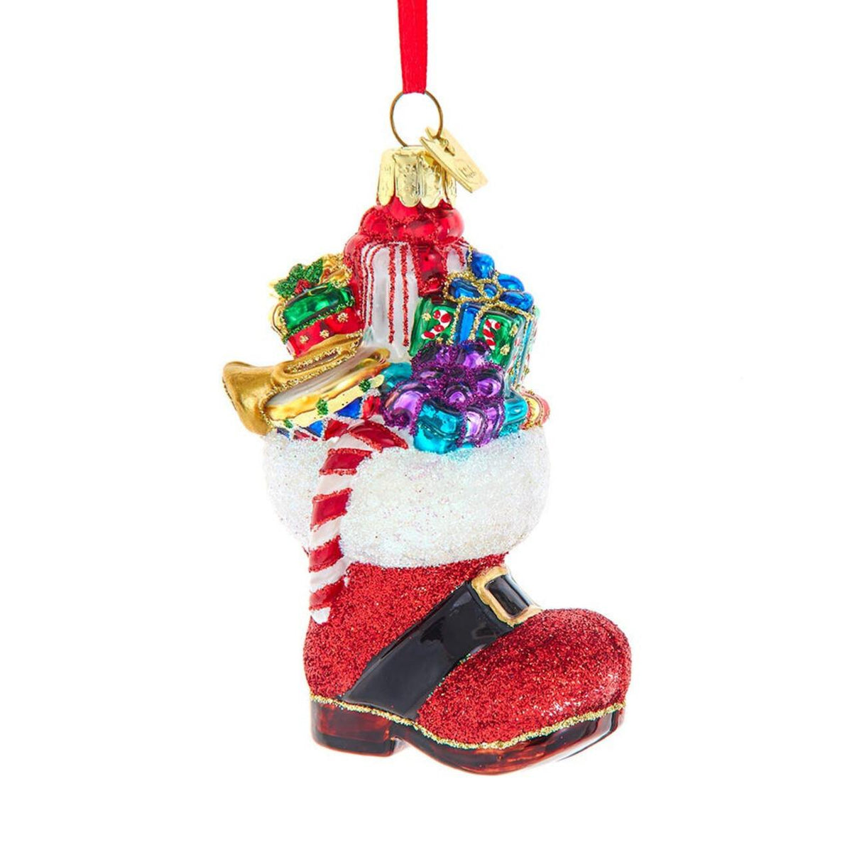 Red glitter glass Santa boot ornament overflowing with gifts, a candy cane and a gold trumpet.