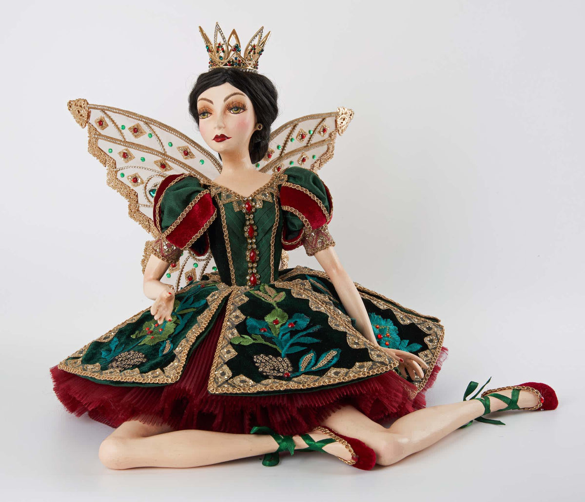 Fairy ballerina doll sitting in a green velvet gown with ruby trim, jeweled crown and jeweled wings